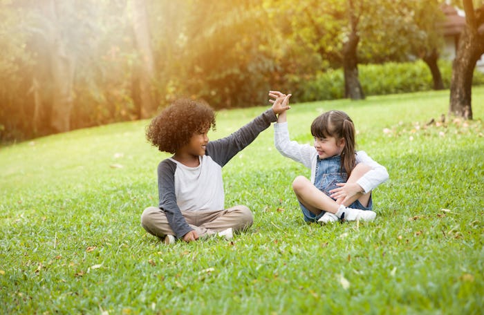 Children playing in the garden in summer day