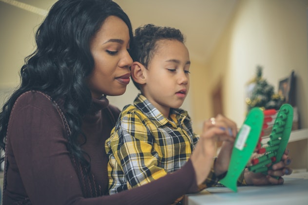 Mother teaching her son to accounting.