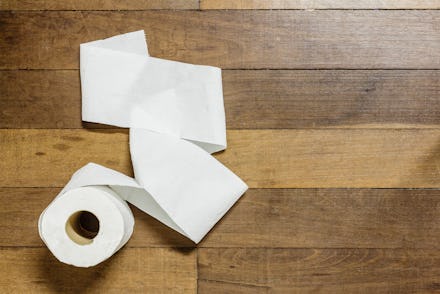 Toilet paper on wood background