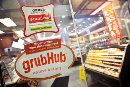 GrubHub, Seamless Signs for GrubHub and Seamless are displayed on the door to a New York restaurant,...
