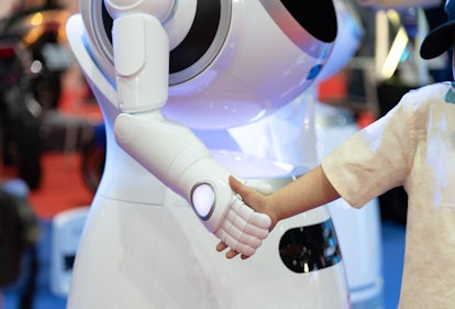 Friendly robot shaking hands with little boy, Technology smart robotic concept