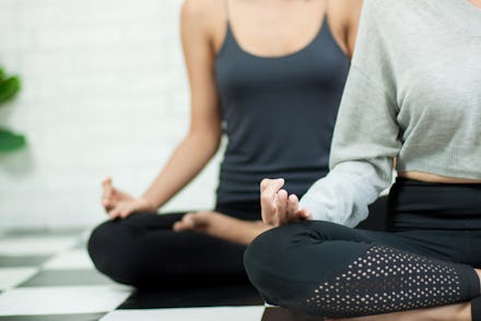 Woman hand in the Yoga exercise and meditation class in healthy plan indoor gym. Female sitting on t...
