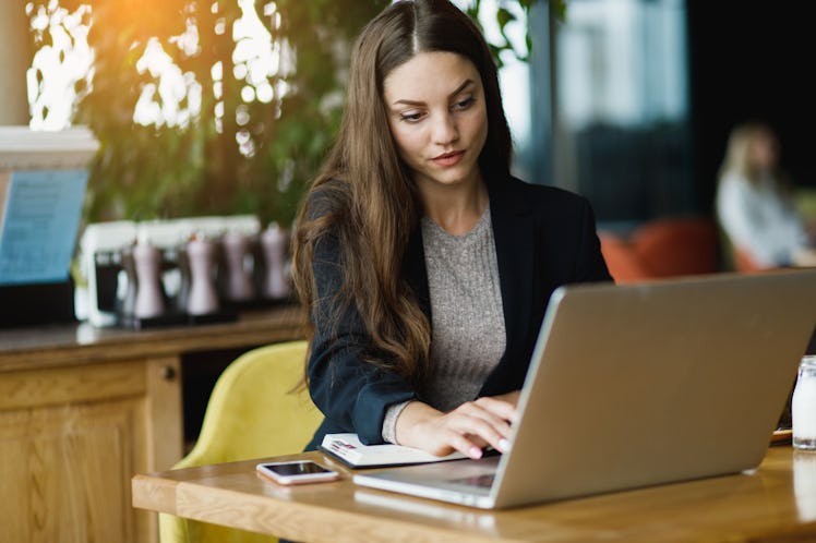 Girl with laptop seriously working