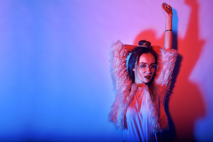 Fashion portrait of young elegant girl in glasses. Colored background, studio shot. Beautiful brunet...