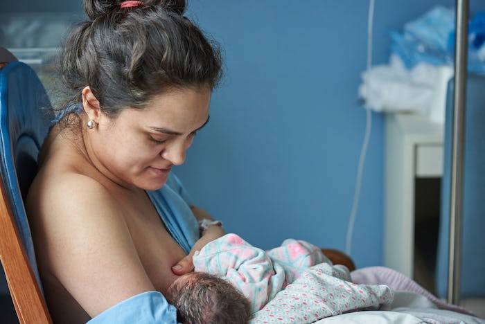 Latina mom breast feeding newborn baby in private hospital