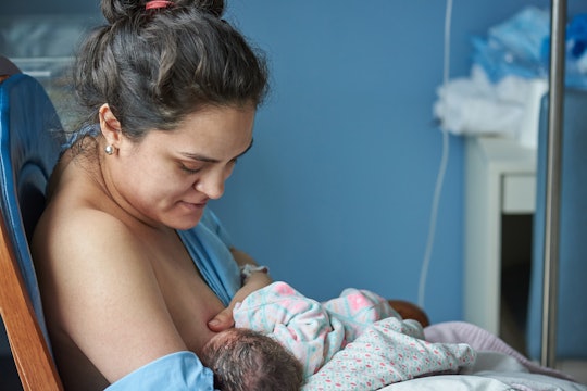 Latina mom breast feeding newborn baby in private hospital