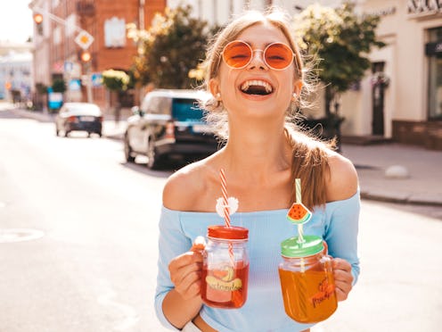 Young beautiful smiling hipster woman in sunglasses.Girl in summer trendy clothes posing in the stre...