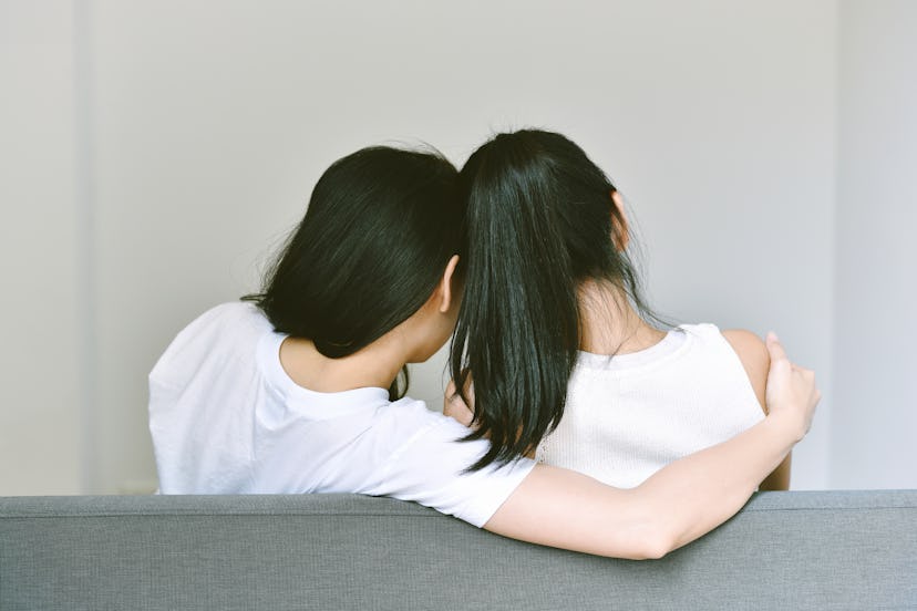 Girlfriends hugging together to encourage and support, Asian lesbian couple lean on the shoulder of ...