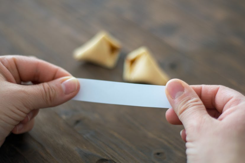Woman opens a fortune cookie