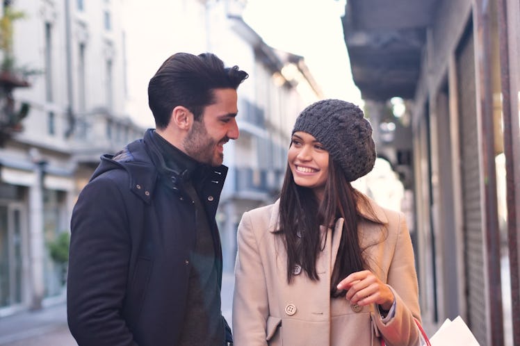 A couple of young engaged or friends, while they are shopping, having fun together. Concept of: shop...