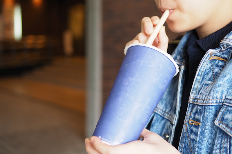 Human drinking water (milk tea). Blue paper cup. Taiwan food