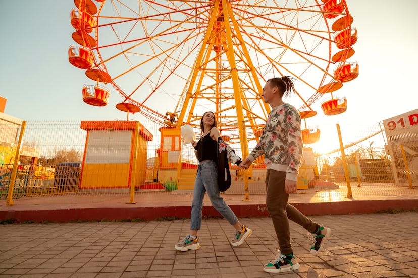 boy and girl in the park at the ferris wheel