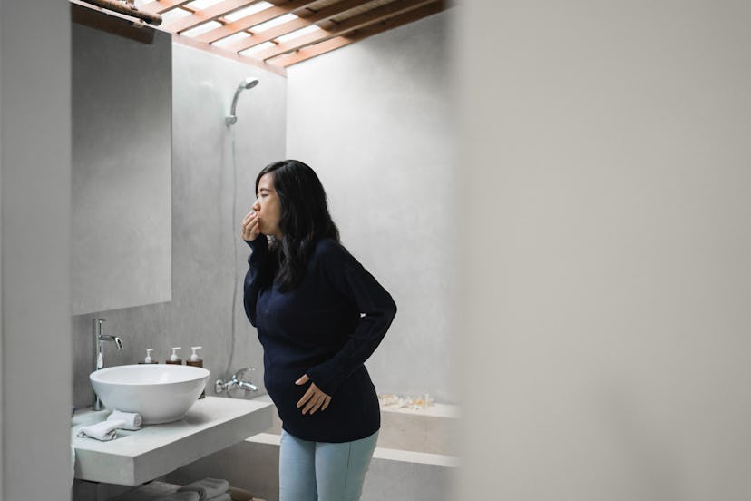 pregnant woman feels nauseous in the bathroom, young asian women get pregnant