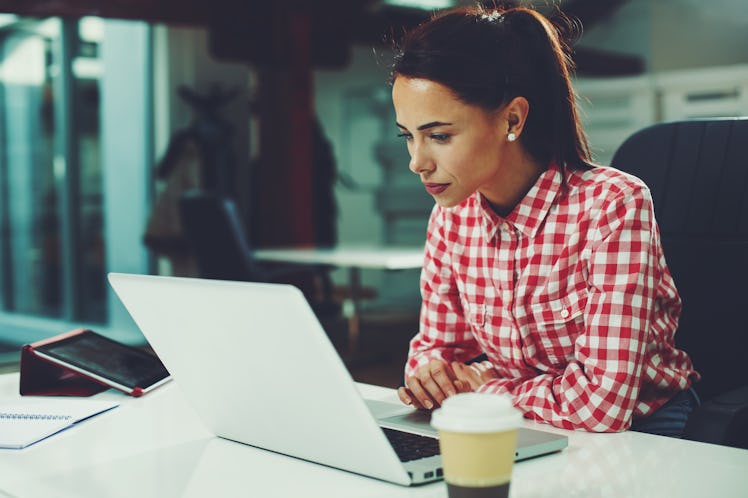 Young woman working on laptop in the office