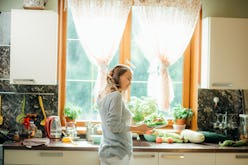 Young Woman Cooking in the kitchen. Healthy Food - Vegetable Salad. Diet. Dieting Concept. Healthy L...