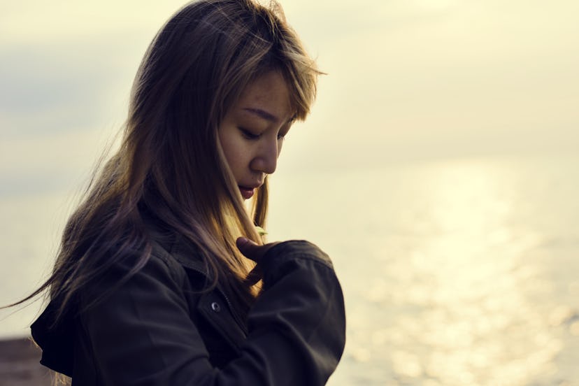 Woman alone on the sunrise beach