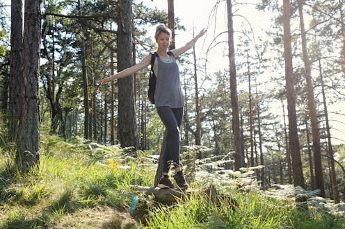 Woman balancing on fallen tree. Freedom ,fun , sport activities in nature
