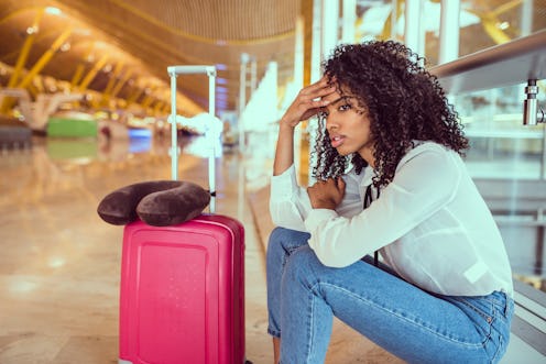 Woman sad and unhappy at the airport with flight canceled