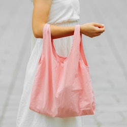 Woman holding cotton eco bag. Reusable eco bag for shopping. Zero waste concept. Mock up