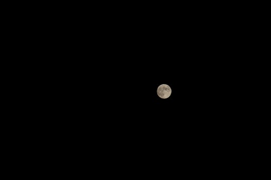 Small moon in a dark sky.