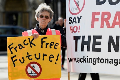 An activist seen holding a placard during the protest.