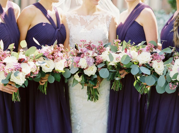 Bride with Bridesmaids in Purple Dresses Holding White and Purple Bouquets
