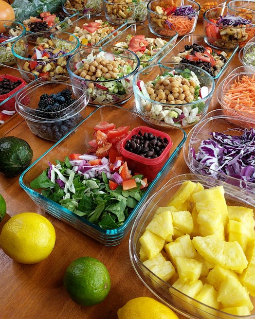 Vegan vegetarian meal prep on wooden table with colorful fruits and vegetables, weekly meal prep spr...