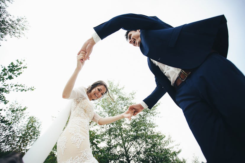 beautiful and happy groom and bride having fun outdoors