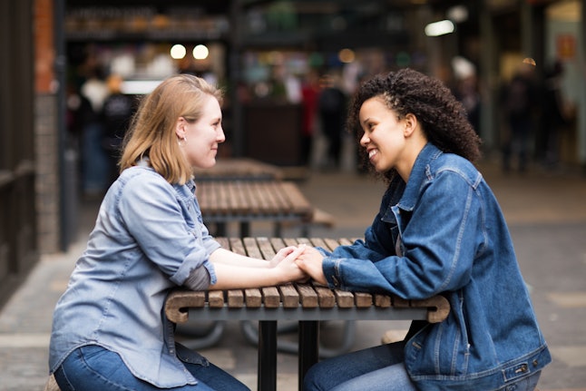 Lesbian couple sitting together chatting