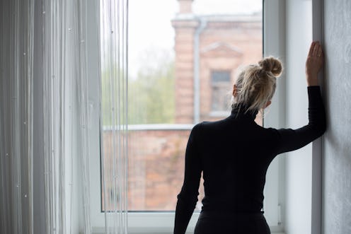 Woman waiting and looking out the window