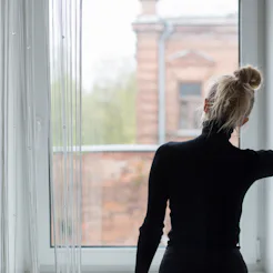 Woman waiting and looking out the window