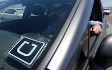 Uber Uber driver Karim Amrani sits in his car parked near the San Francisco International Airport pa...
