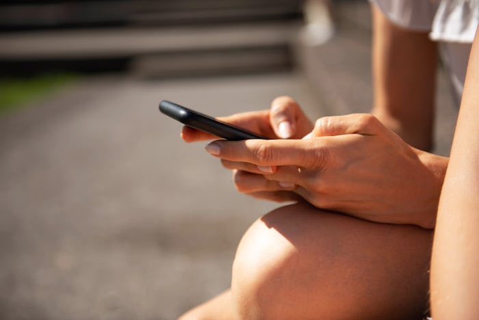 Women hands Typing on mobile phone