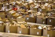 A worker stands between boxes at an Amazon distribution center during 'Black Friday' in Madrid, Spai...