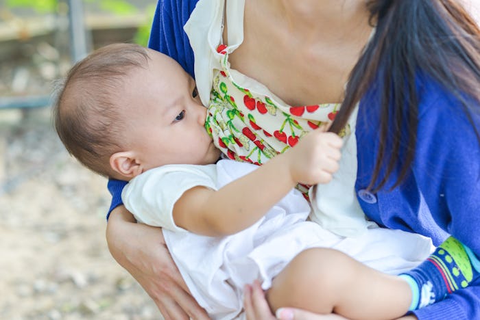 Young mother breast feeding her baby girl