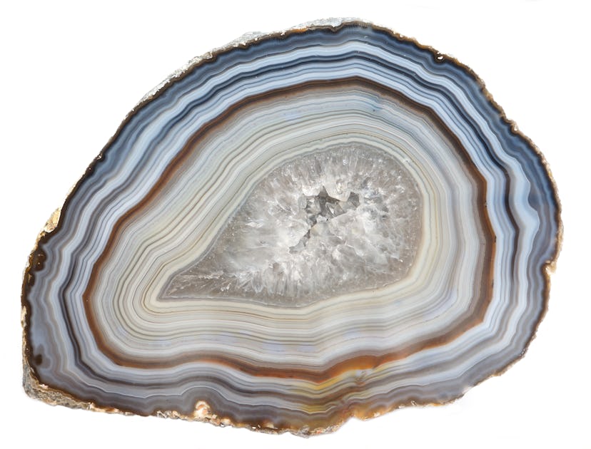 A banded Agate specimen with a geode of Quartz crystals
