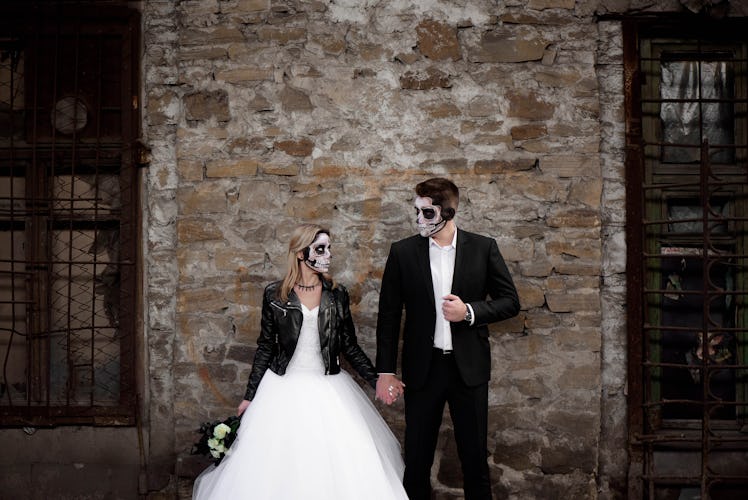 Halloween couple. Dressed in wedding clothes romantic zombie couple. Halloween concept. Fashion phot...