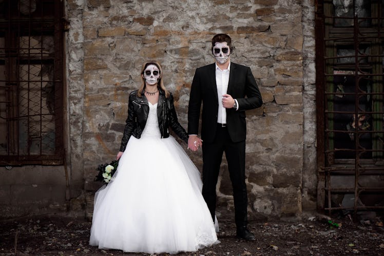 Halloween couple. Dressed in wedding clothes romantic zombie couple. Halloween concept. Fashion phot...