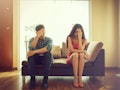 Unhappy couple sitting on couch after quarrel fight thinking of break up or divorce, black upset man...