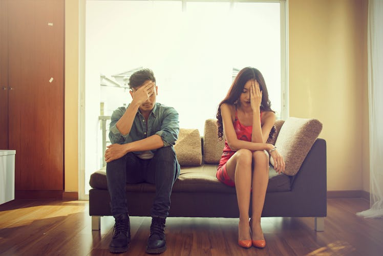 Unhappy couple sitting on couch after quarrel fight thinking of break up or divorce, black upset man...