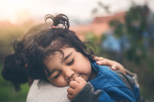 A Sad Indian Daughter Hugging Mother Outdoors. Mom with Her Kid, Little Girl with Frustrated Face Em...