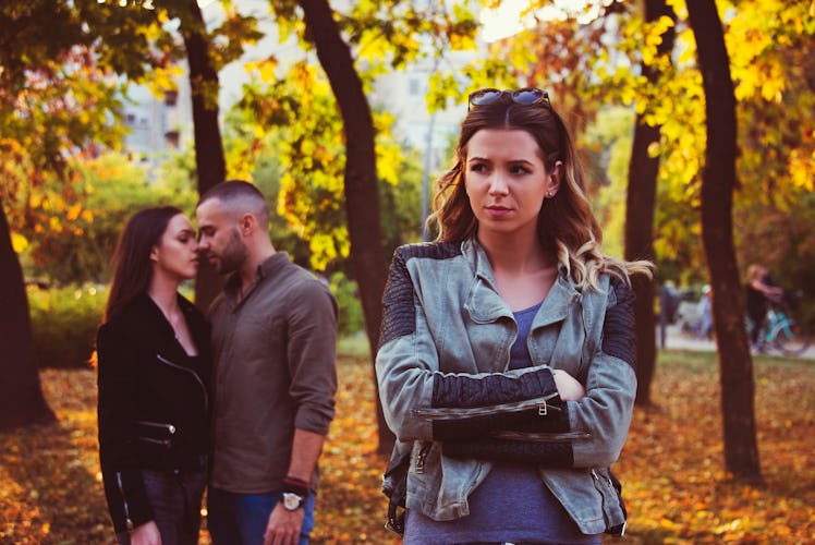 relationship concept tree people arguing  outdoor in park problems, secret behind back