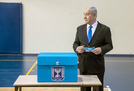 Israeli Prime Minister Benjamin Netanyahu prepares to cast his ballot during the Israeli legislative...