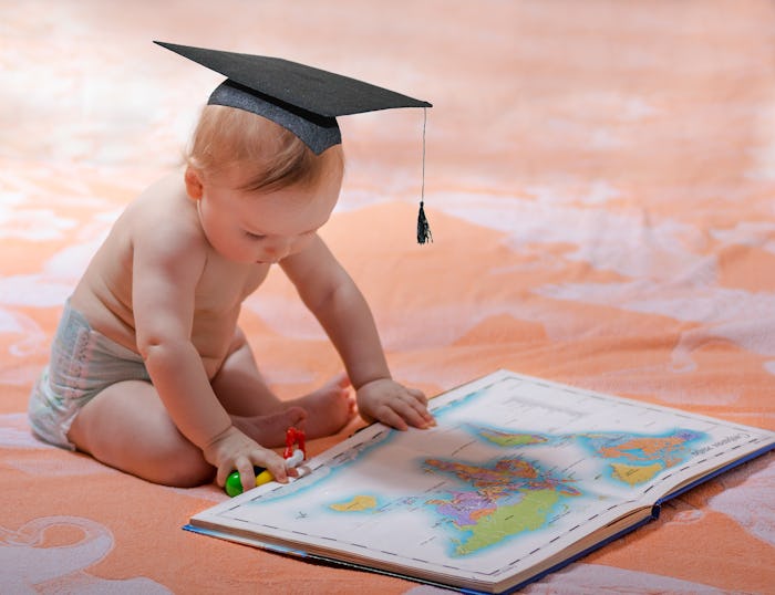 Baby with square academic cap and maps of the world