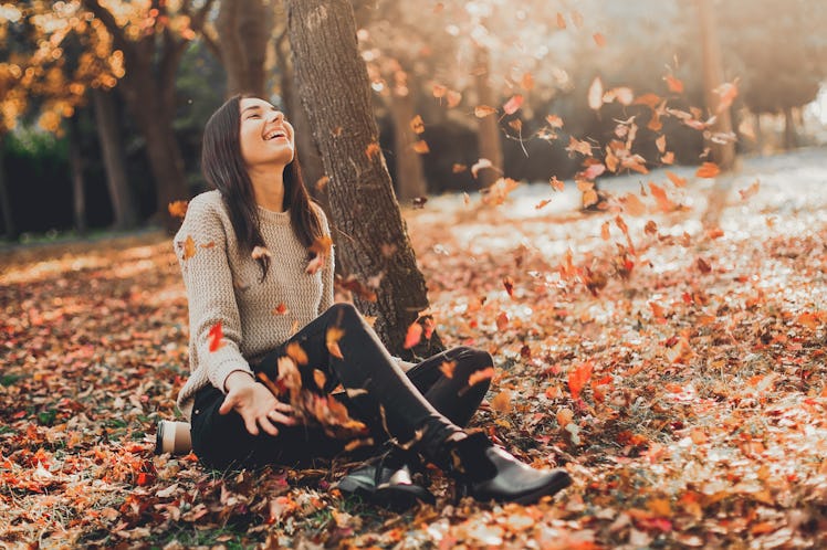 Happy Autumn. Beautiful woman having fun in fall park.