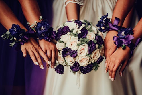 Bride with bridesmaids hand with beautiful flowers