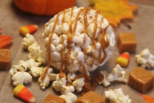 Close up of a Halloween popcorn ball with caramel