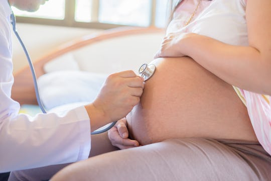 doctor using stethoscope white examining pregnant woman in clinic,Medical exam new born concept,vint...