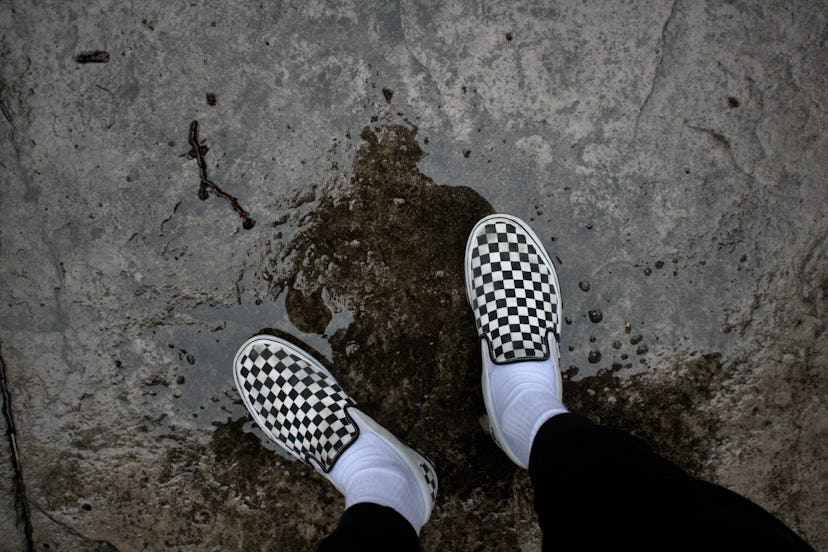 Checkered Vans in a puddle