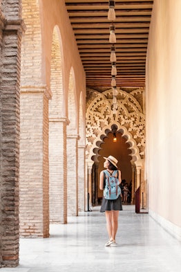 Woman traveler at the Aljaferia, one of the most famous places in Zaragoza. Moorish Islamic palace i...